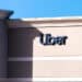 Orlando, USA - January 16, 2021: Florida city with closeup of sign and entrance to building for Uber business company office