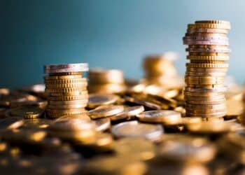 Stack of gold coins against blue background