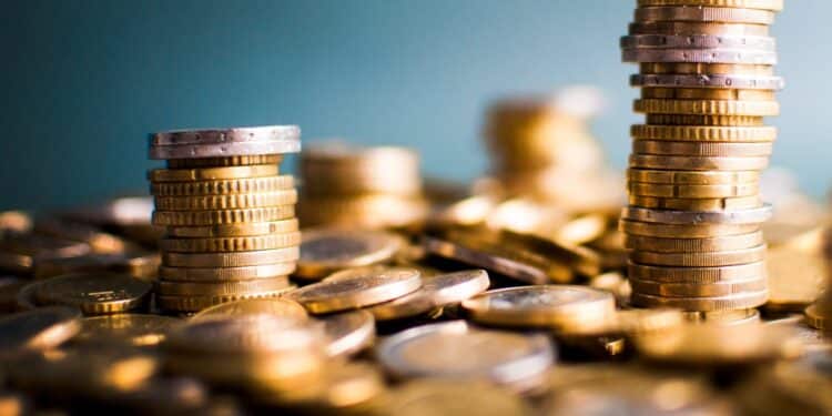 Stack of gold coins against blue background