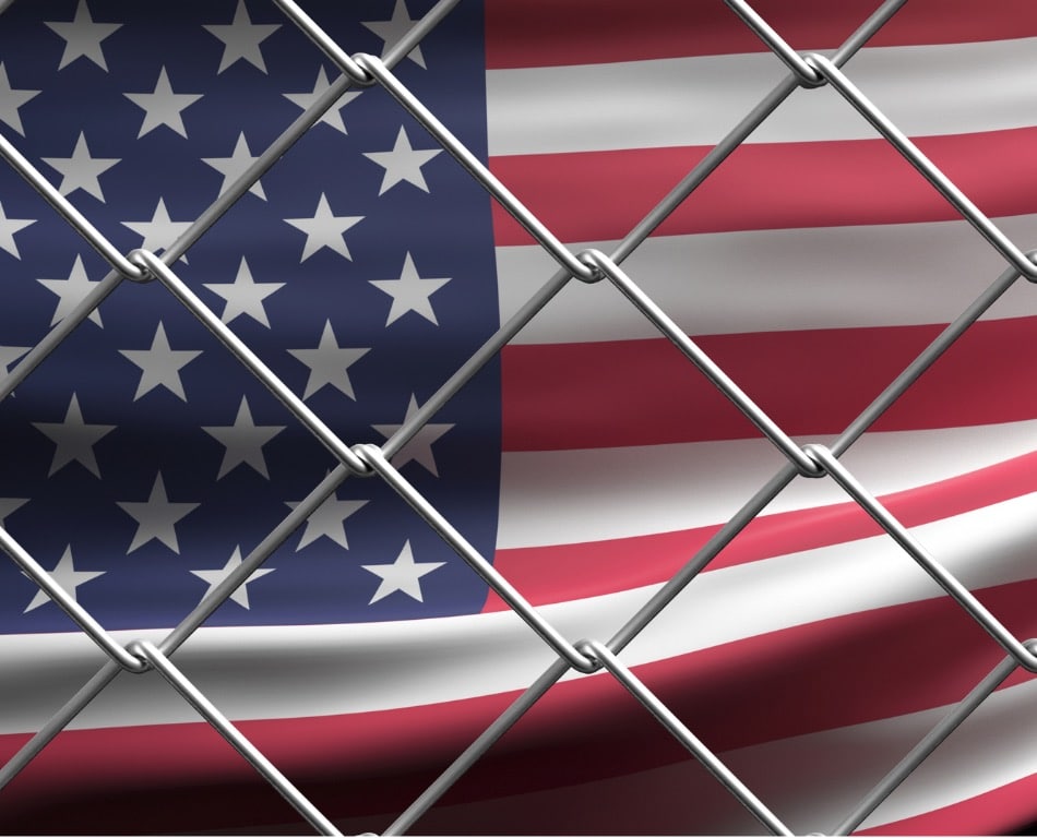 U.S. flag behind a wire fence