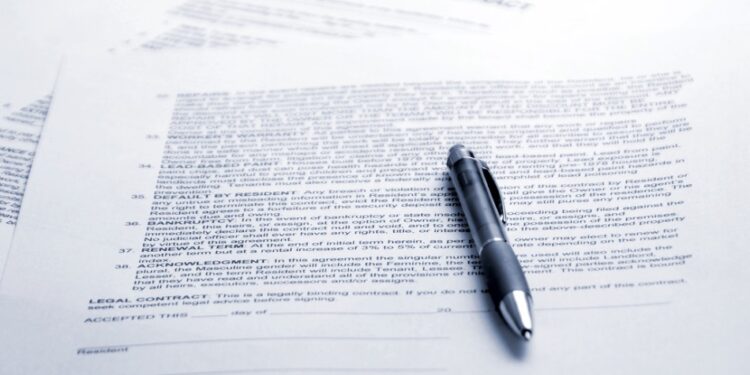 Image of a contract with a pen laying on top of it