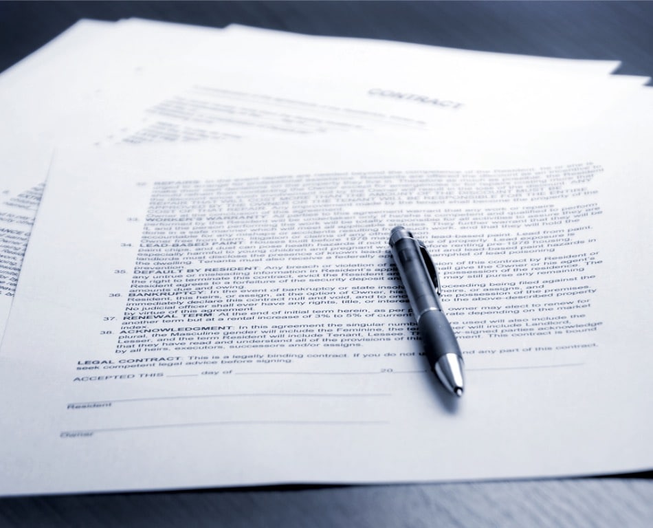 Image of a contract with a pen laying on top of it